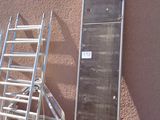 a ladder leaning against a building next to a ladder