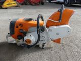 a chainsaw sitting on the ground in a parking lot