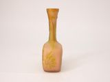 a small glass vase with a yellow design on it