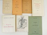 several books are lined up on a white surface