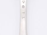 a spoon that is sitting on a white surface