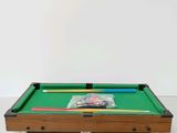 a pool table with a pool cues and a ball on it