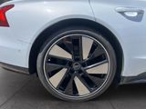 the rear end of a white car with black rims on it