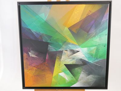 painting of a colorful abstract painting on a wooden easel with a white background