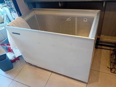a white chest freezer sitting in a kitchen
