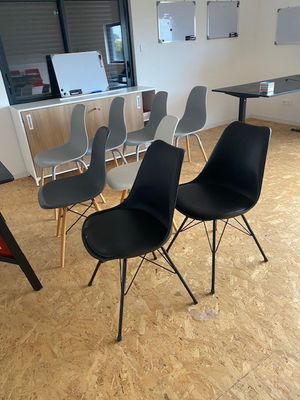 four chairs sitting in a room with a table and chairs