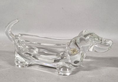 clear glass dog figurine sitting on a white surface