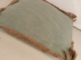 an image of a green pillow with fray edges