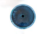 a blue vase with a hole in the middle of it
