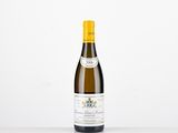 a bottle of white wine sitting on top of a table