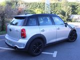 a white mini cooper parked in a parking lot