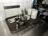 pots and pans sit on a metal tray in a kitchen