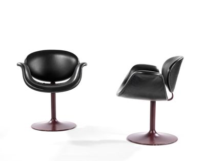 pair of black leather chairs with red bases on a white background