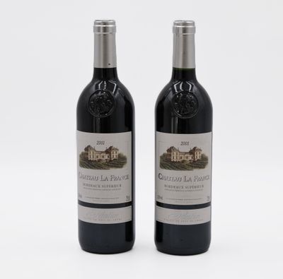 two bottles of red wine sitting next to each other on a white surface