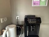 a coffee maker and a cup on a counter