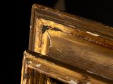 a close up of a gold frame with a black background