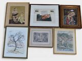 many framed pictures on the wall of this room