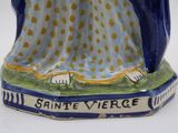 a figurine of a woman in a blue dress
