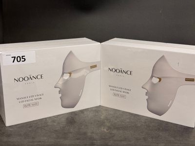 two boxes of noorance products on a table with a clock in the background