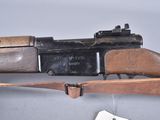 an old rifle with a wooden handle and a wooden sling