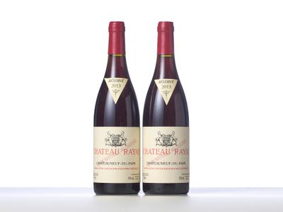 two bottles of red wine sitting next to each other on a table
