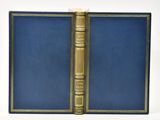 a blue book with gold trim and a golden book cover