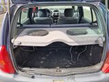 l'arrière d'une voiture dont le coffre est ouvert et où se trouve une enceinte de graves