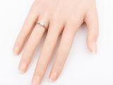 an image of a woman ' s hand with a diamond ring on it