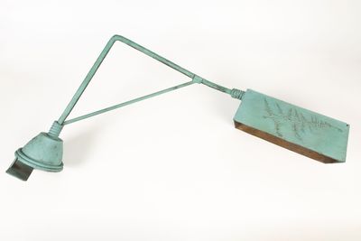 a green light that is attached to a metal pole