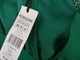 a close up of a green jacket with a price tag on it