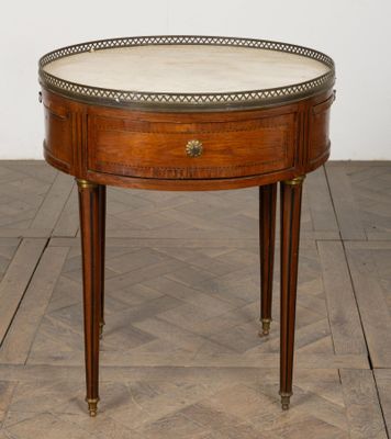 an image of a small table with a marble top on a wooden floor