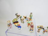 many figurines that are sitting on a clear shelf