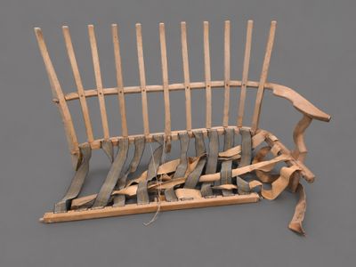 a wooden bench that has a bunch of knives on it