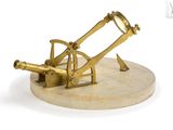 an antique brass telescope on a marble base on a white background