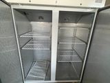 an empty refrigerator in the middle of a dirty floor