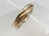 a close up of a gold ring on a clear ring holder