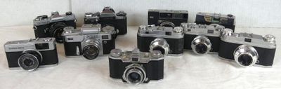 a lot of cameras that are sitting on a table