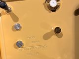 a yellow clock that is on display on a table