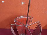 an umbrella and a glass holder on a table