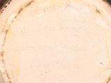a close up of a white vase with writing on it