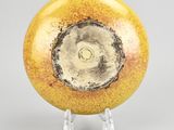 an image of a yellow and black vase on a clear stand