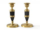 pair of black and gold candlesticks on a white background