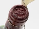 a close up of a wine bottle with a stamp on it