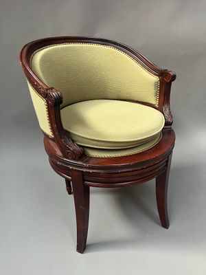an old chair with a yellow cushion on top of it