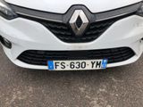 the front of a white car with a number plate on it