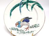 a plate with a painting of a bird on it