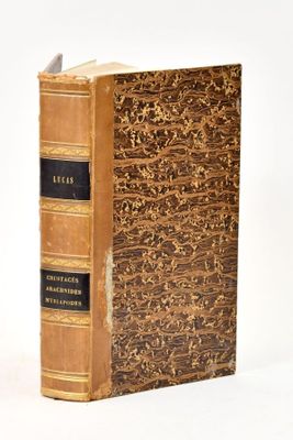an old book that is sitting on a white surface