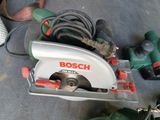a bosch circular saw on the floor next to other tools