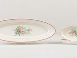 a close up of two plates with flowers on them on a table
