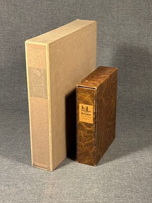 two books sitting next to each other on a gray surface